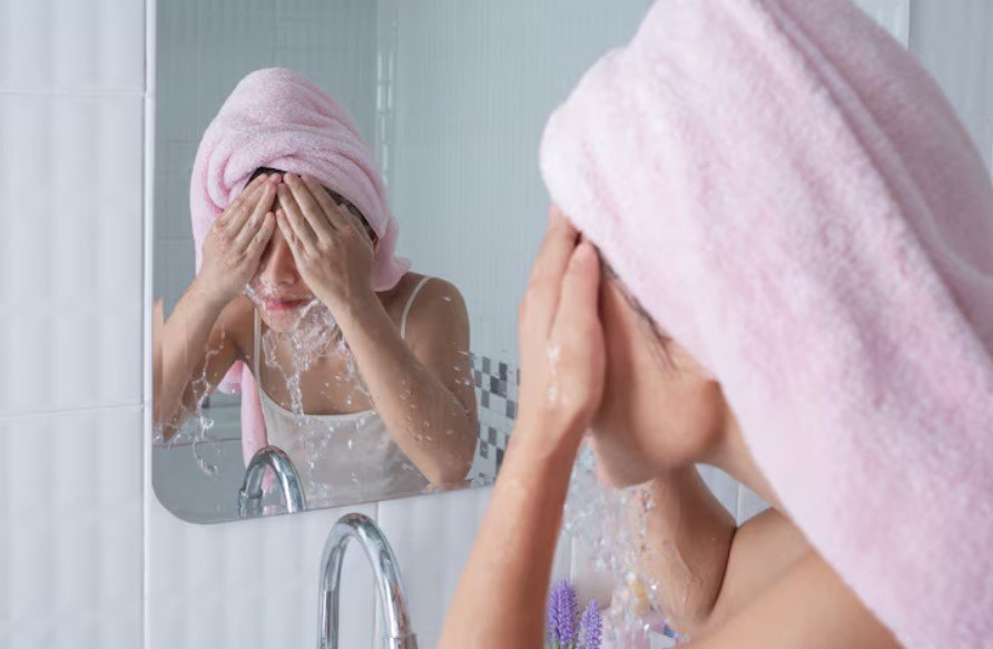 woman cleansing oily skin with face wash