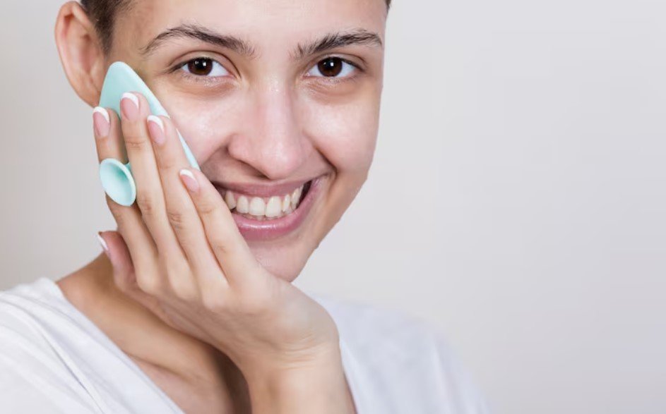 Woman moisturizing her face as the final step of a skincare routine